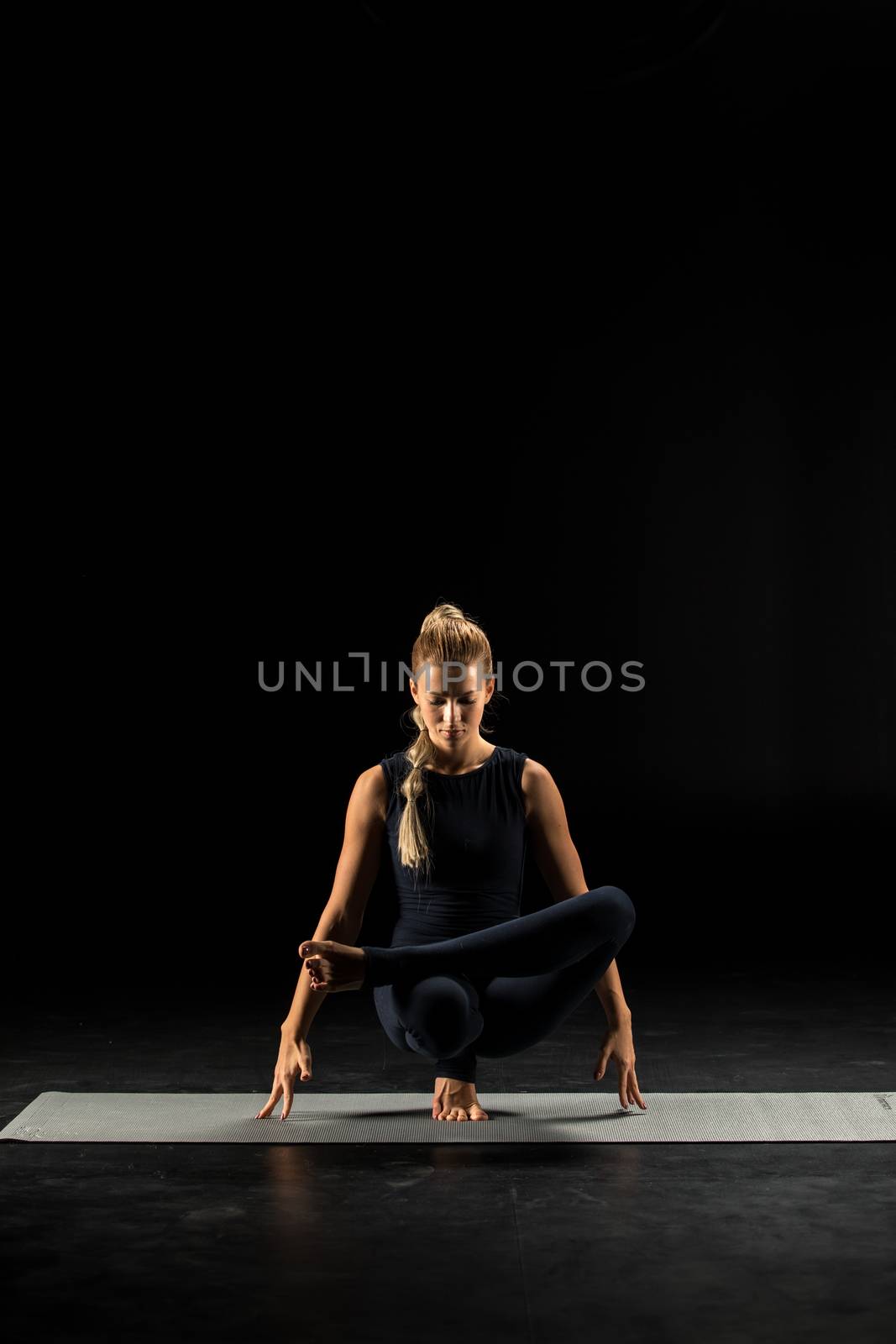 Woman standing in yoga position        by LightFieldStudios