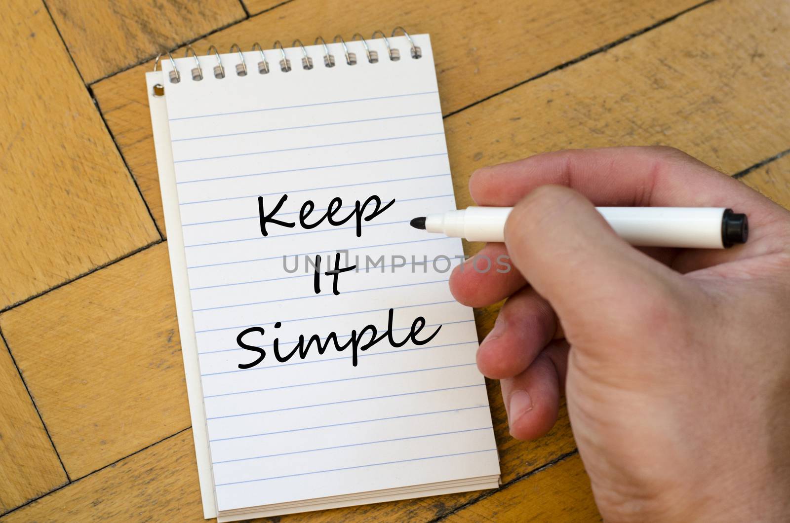Keep it simple text concept write on notebook