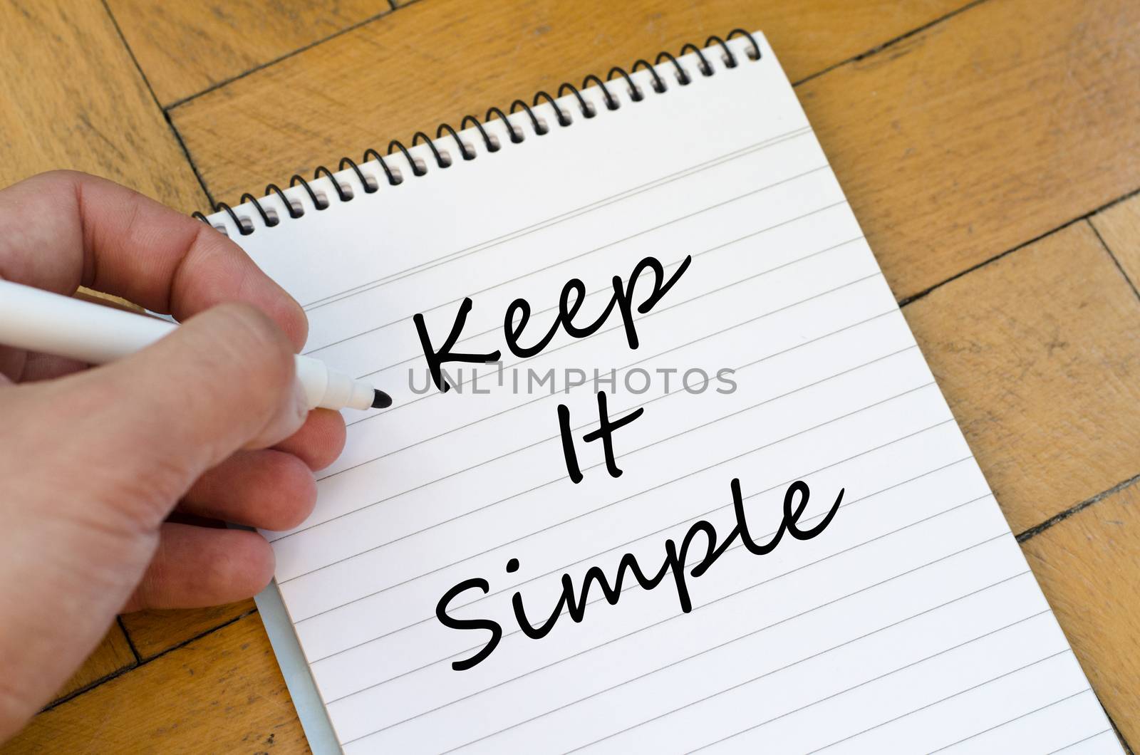 Keep it simple text concept write on notebook