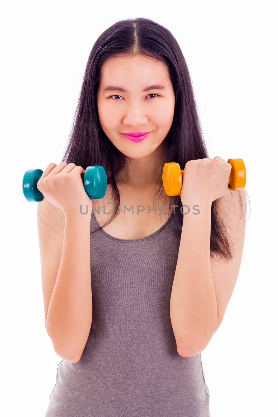 Teenage Chinese girl holding a pair of dumbbells