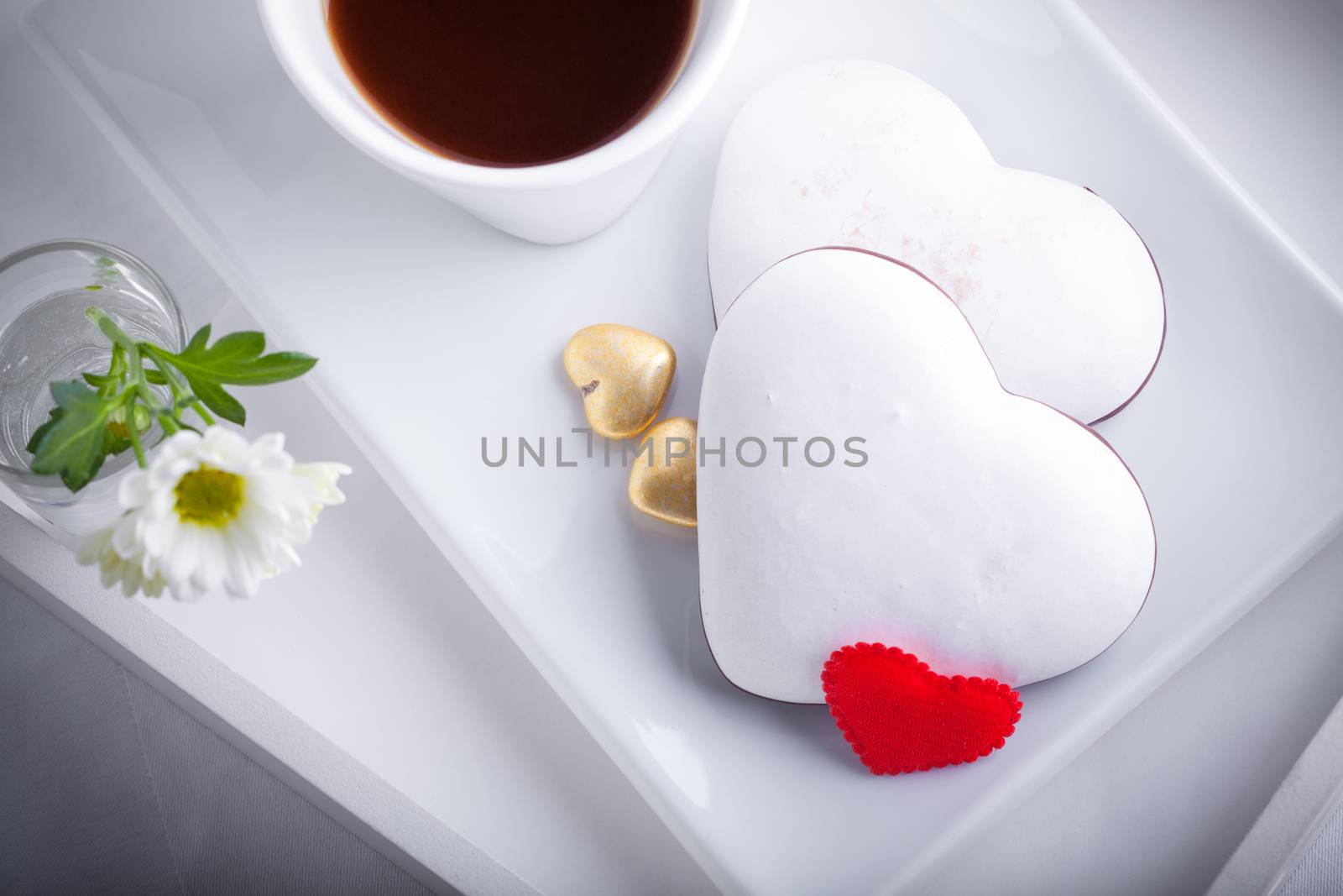 Cookies and coffee on a white plate. Valentine symbols.