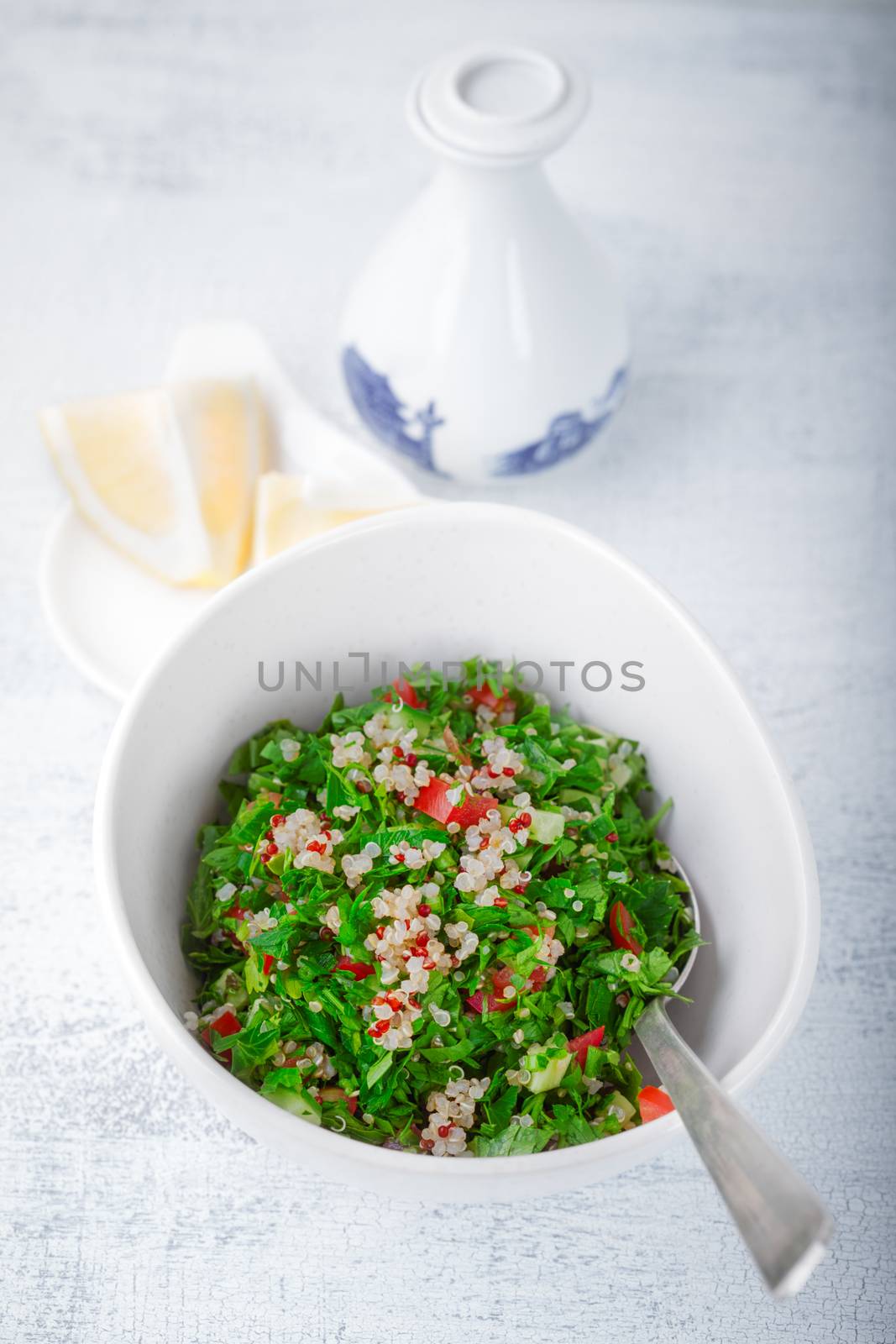 Quinoa tabbouleh salad on a wooden table by supercat67