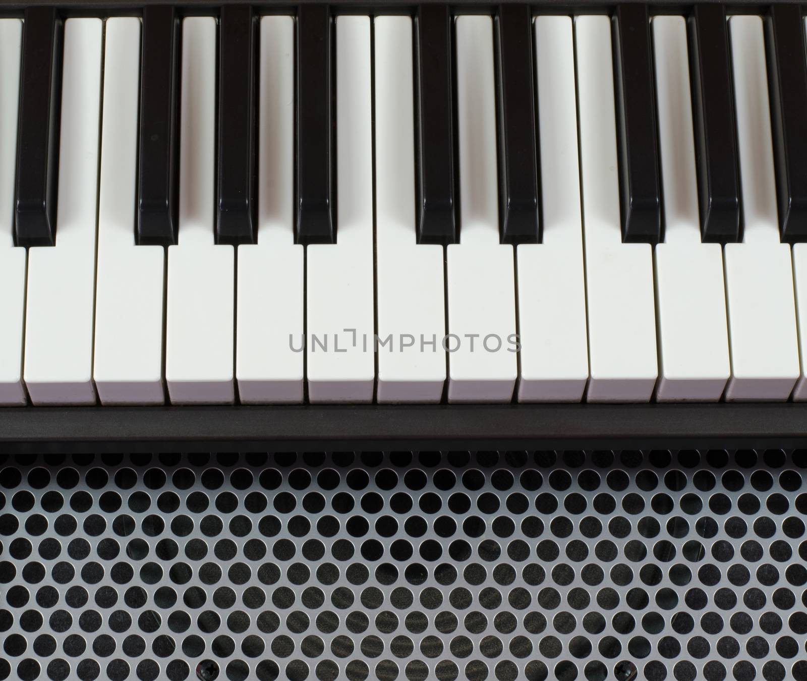 Synthesizer keyboard music instrument, studio shot at interesting perspective on Metal surface