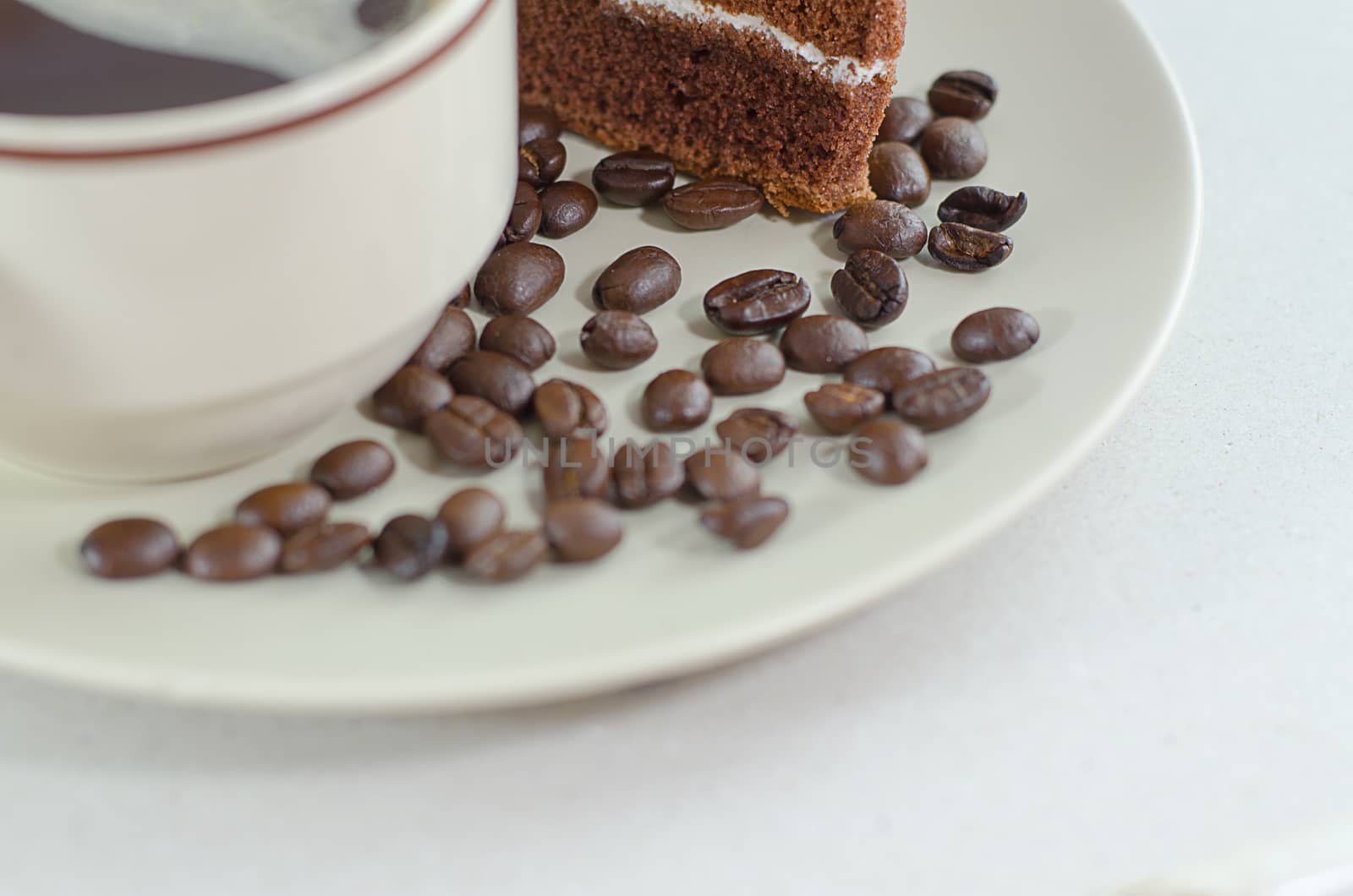 A cup of coffee with slice of chocolate cake on White background