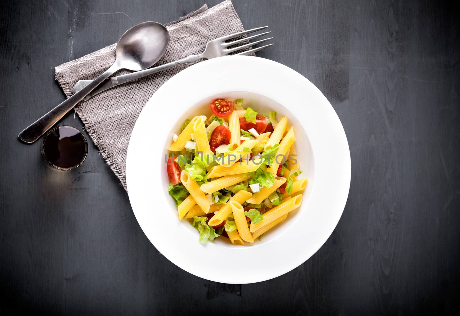 Pasta salad with fresh greenery and tomatos