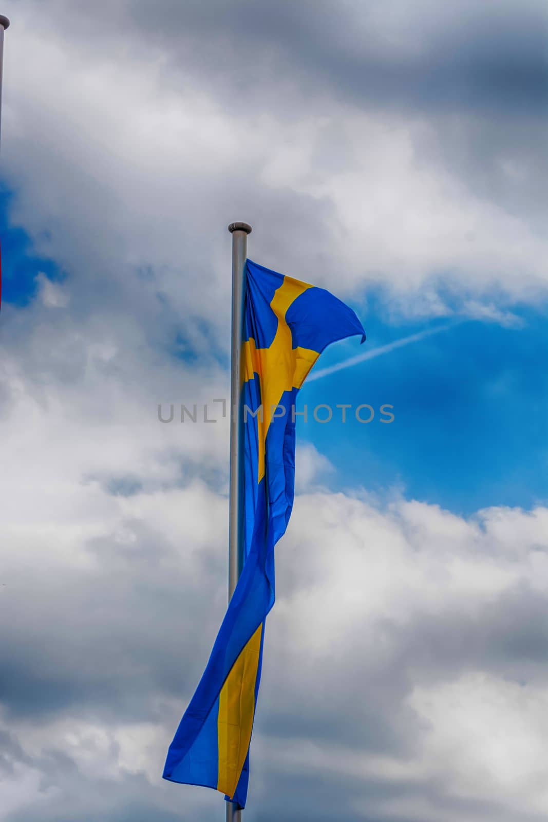 Swedish country flag arranged against a blue sky.