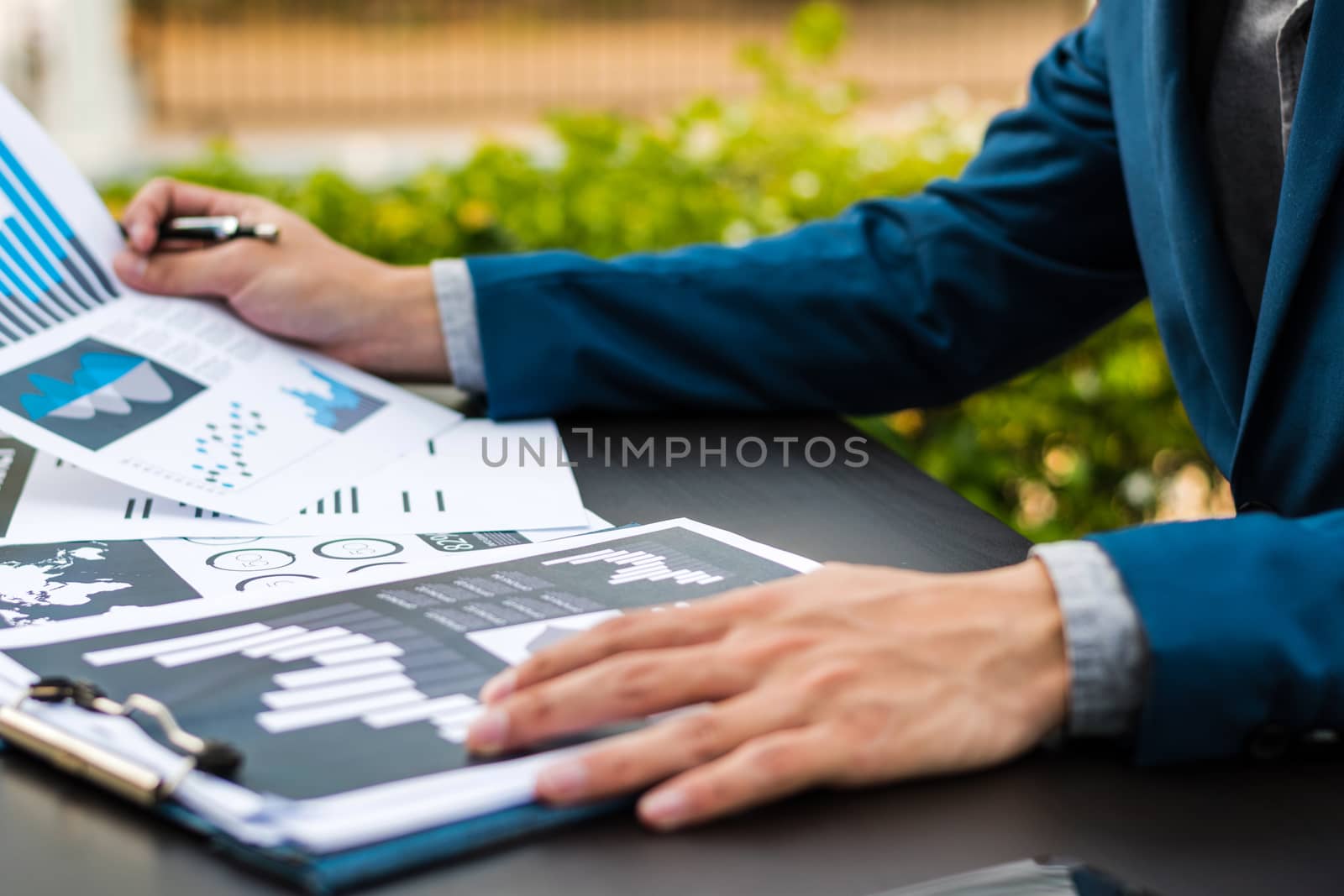 Handsome businessman wearing suit and using modern laptop outdoo by dfrsce