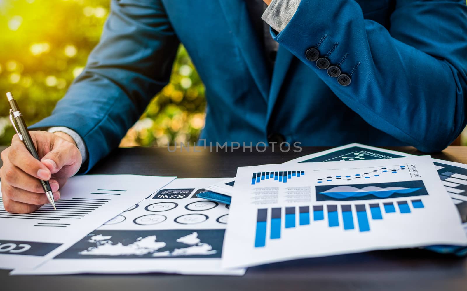 Handsome businessman wearing suit and using modern laptop outdoo by dfrsce