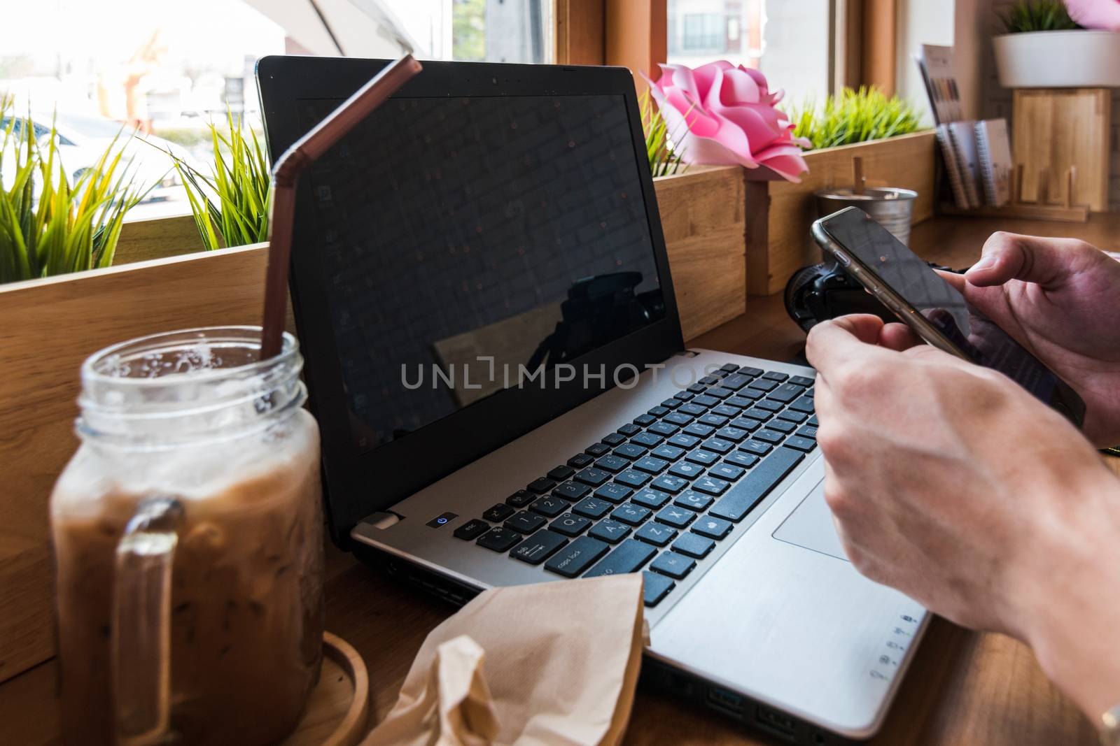 Coffee cup  on a table with laptob and graph finance diagram in coffee shop.