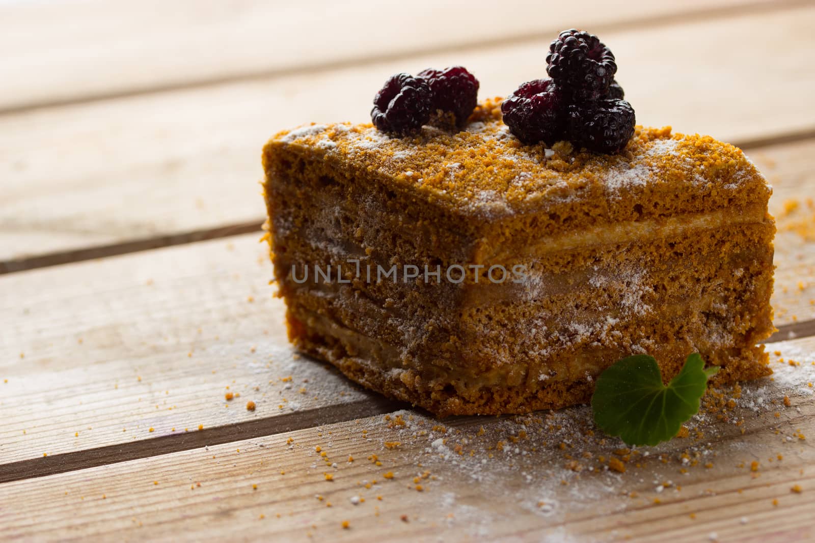 cake with blackberry on rustic wooden background