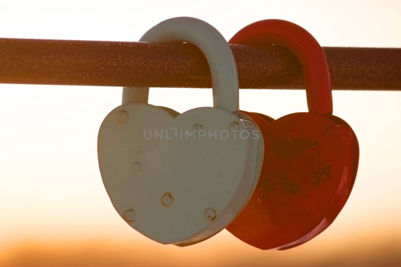 two heart shaped padlocks, beautiful sunset sunbeans