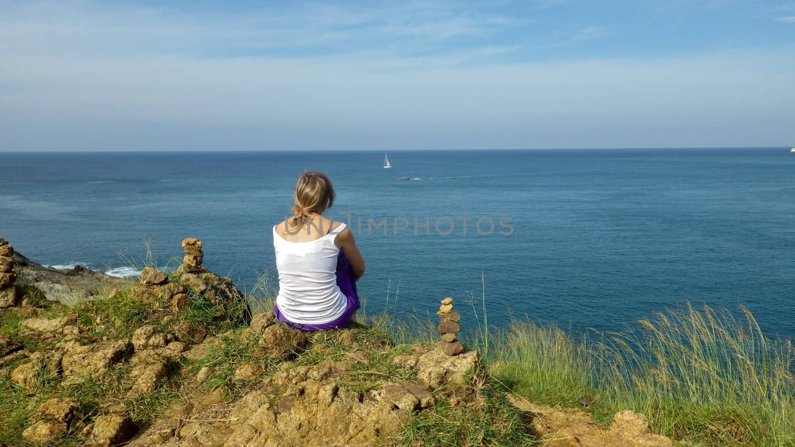woman enjoys views of the sea. A relax on the seashore. Supervision over the horizon. by evolutionnow