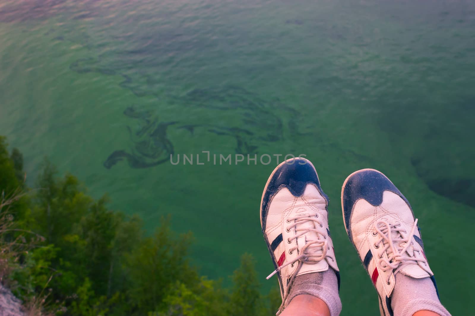 Feet hanging in the air. above the sea