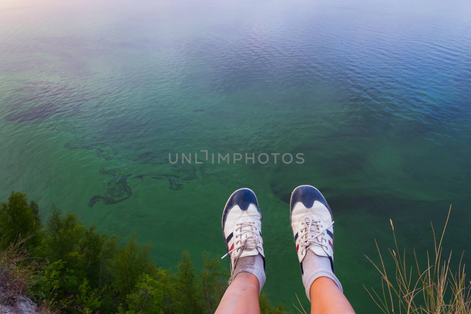 Feet hanging in the air. above the sea