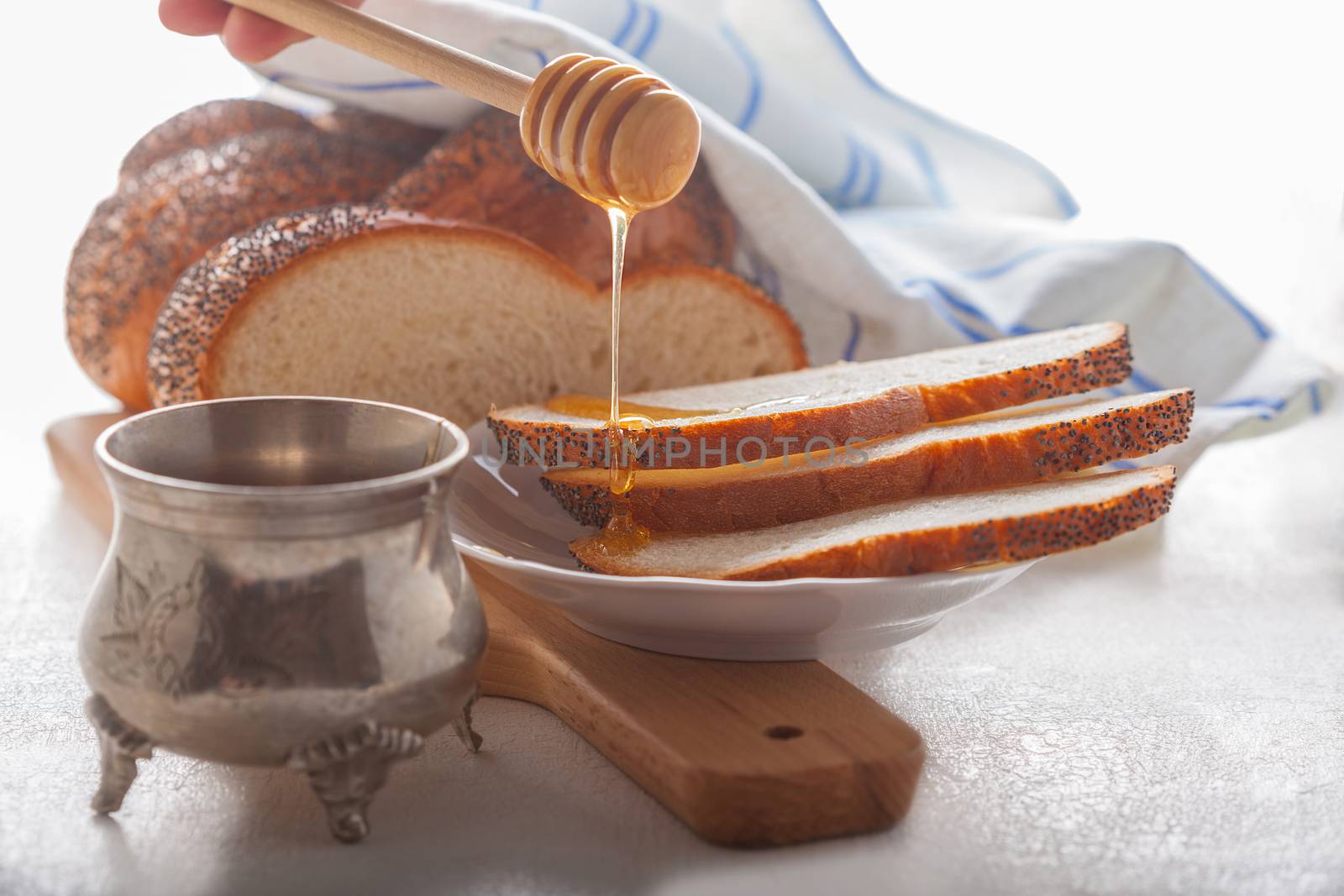 Braided Challah bread and honey on the table