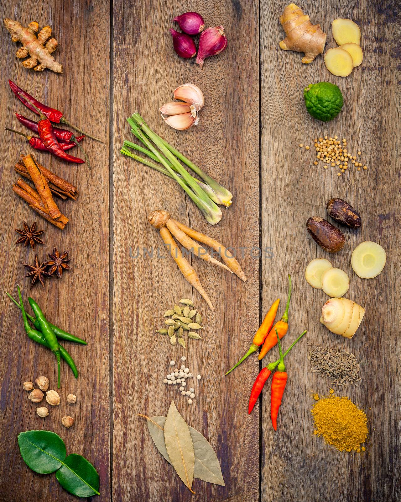 Various of Indian spices and herbs. Cooking ingredients and red curry paste . Ingredients of thai popular food on rustic wooden background. All spices with flat lay.