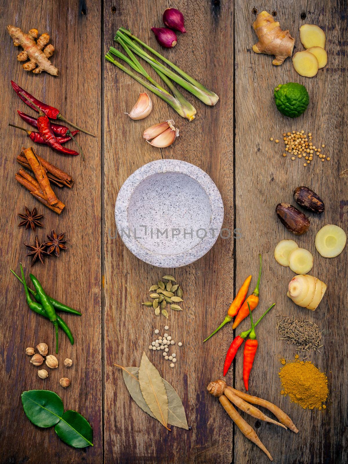 Various of Indian spices and herbs. Cooking ingredients and red curry paste . Ingredients of thai popular food on rustic wooden background. All spices with flat lay.
