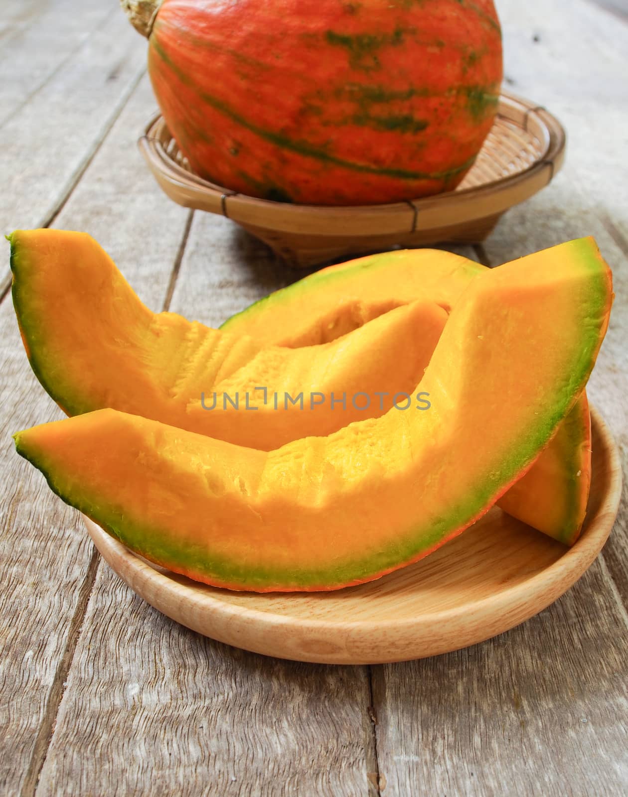 Place the pumpkin on a plate on a wooden table.
