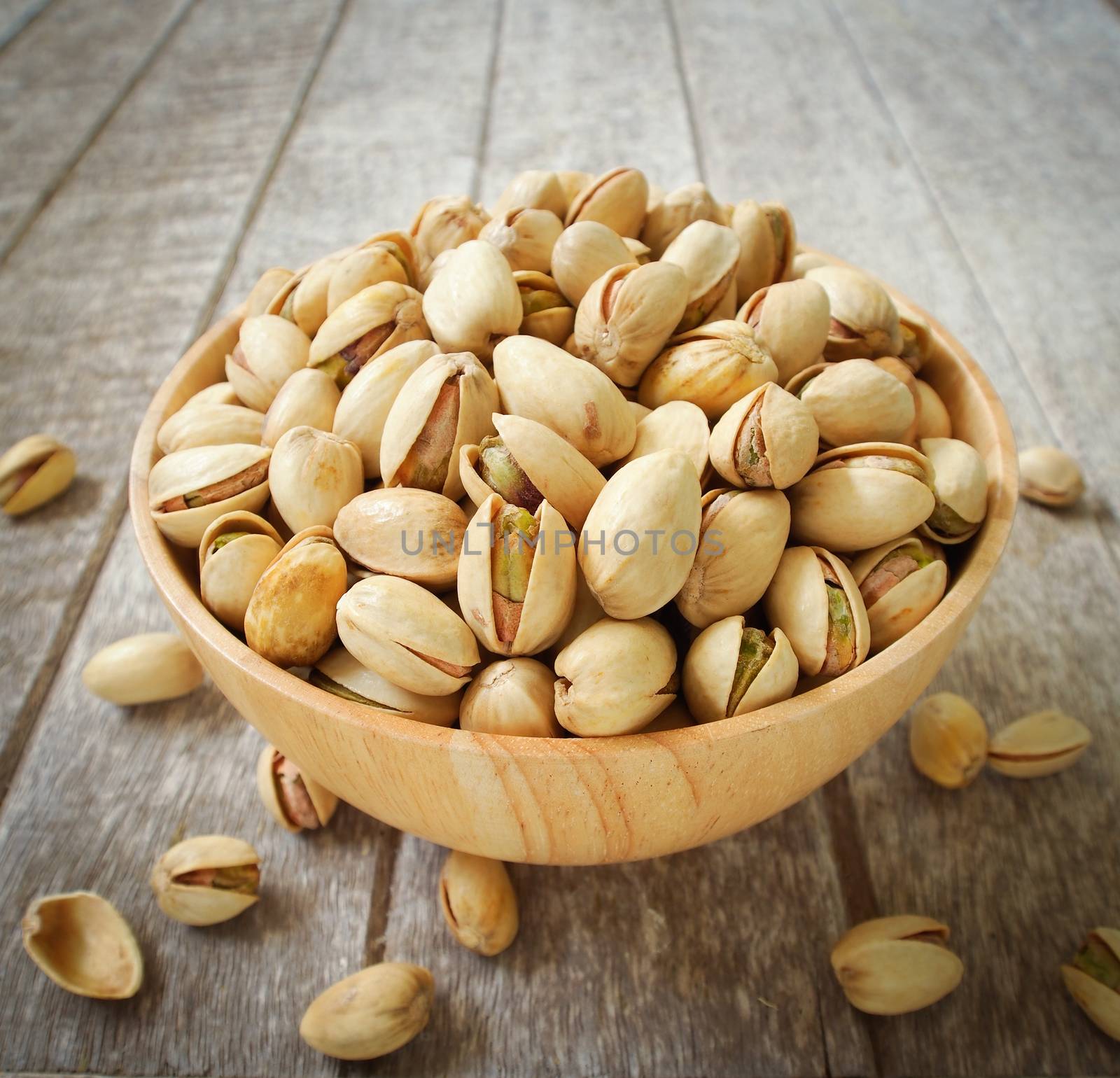 Pistachio nuts in wood cup ,closeup