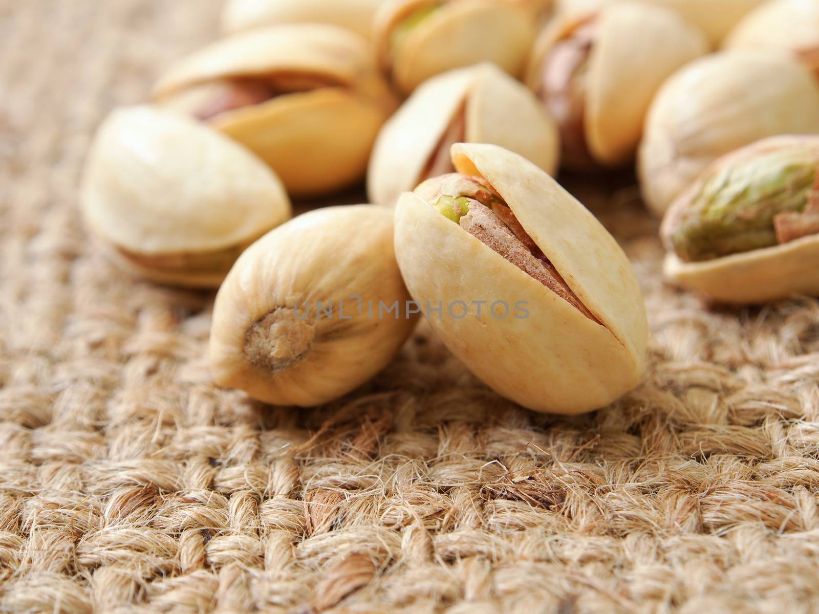 Pistachio nuts on sack background ,closeup