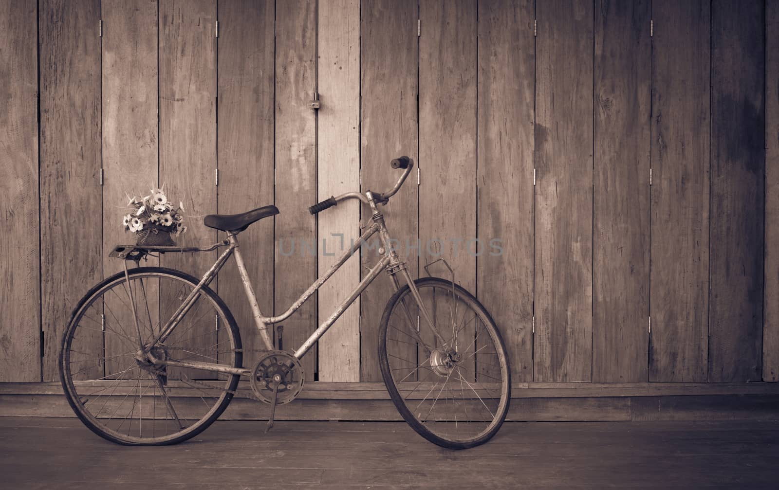 vintage bicycle on wooden house wall