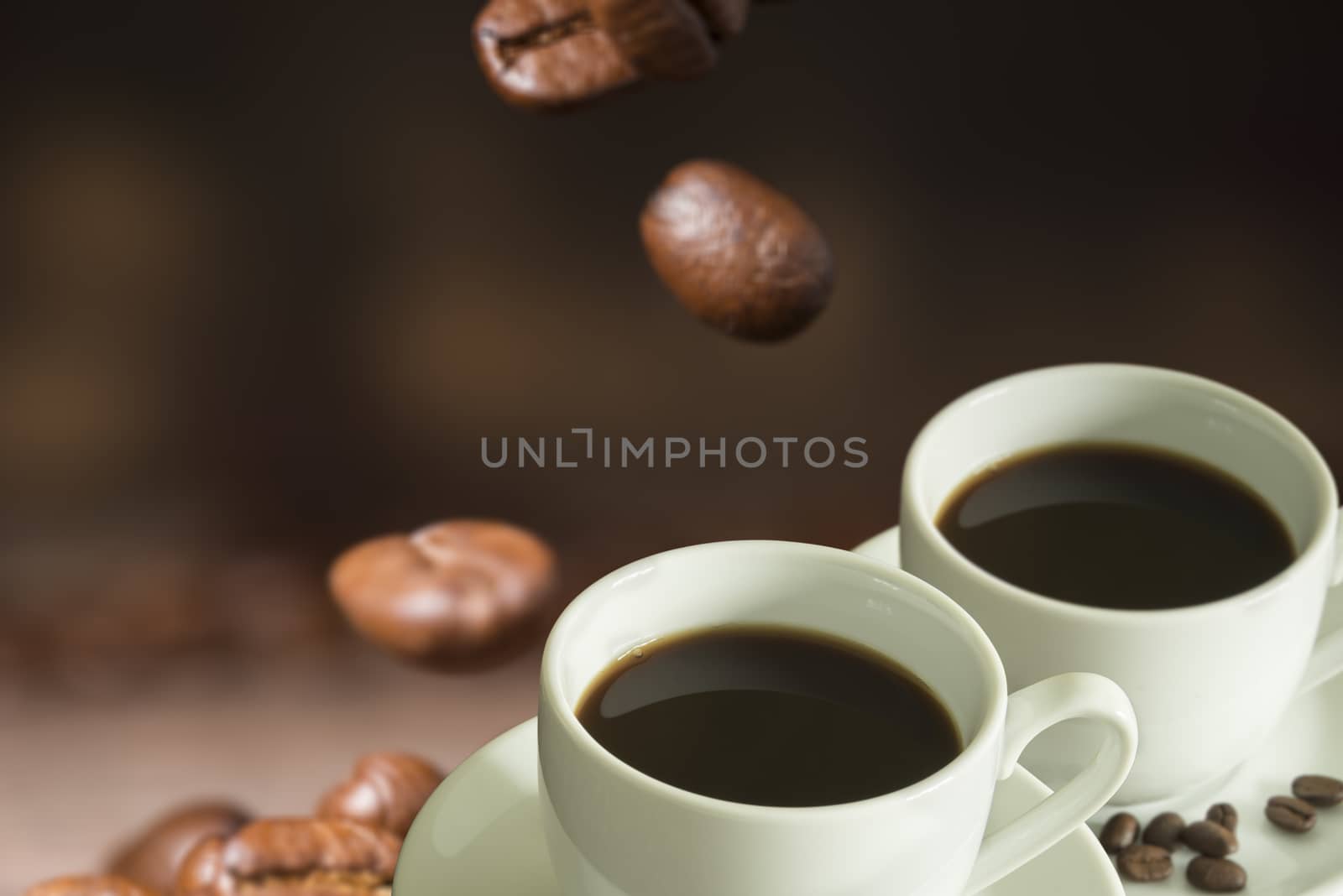 Cup of coffee and coffee beans on a wooden table.