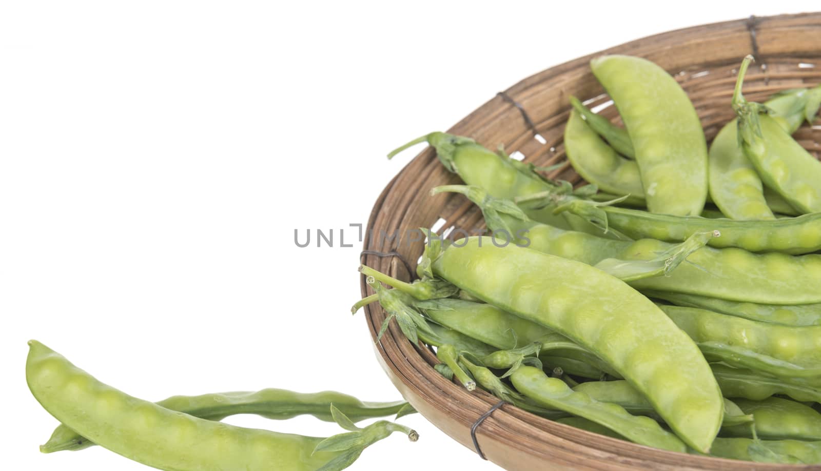 String bean in a basket isolated on a white background.