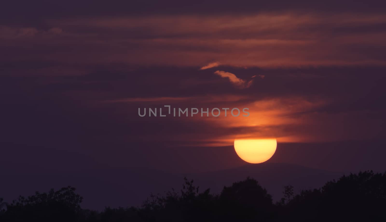 Bright big sun on the sky with clouds