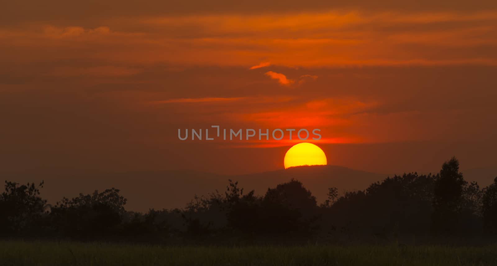 Bright big sun on the sky with clouds