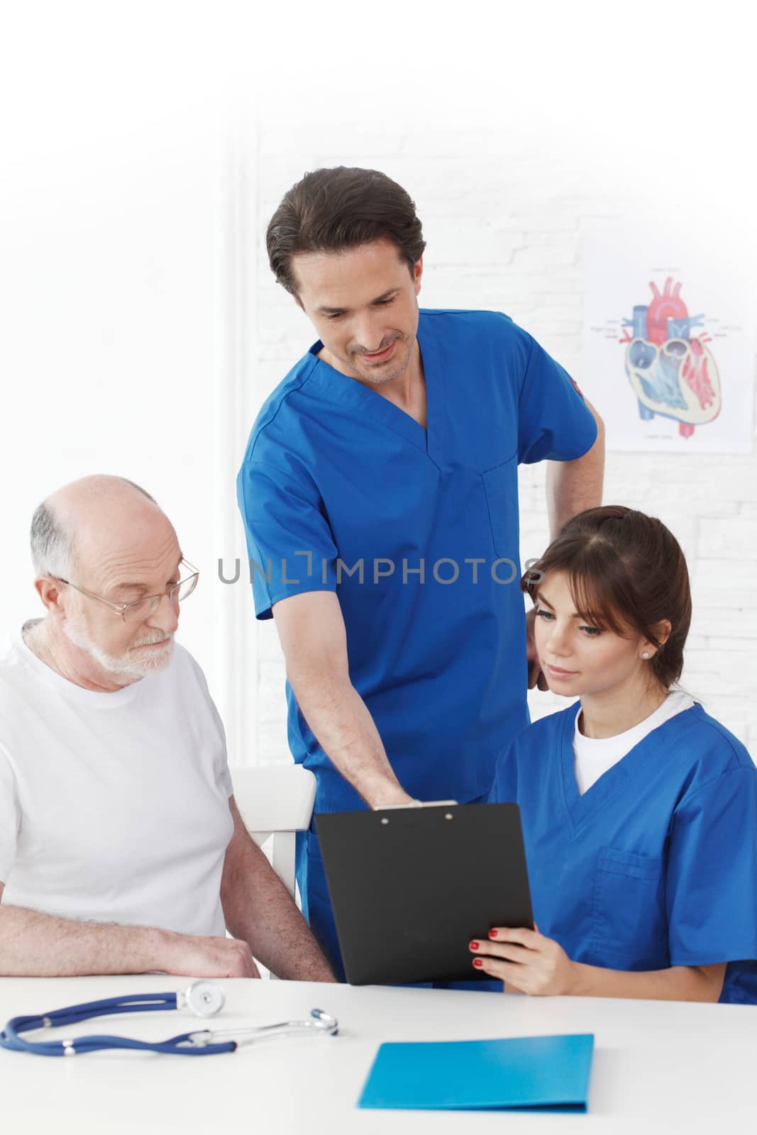 Happy senior patient and doctors in hospital