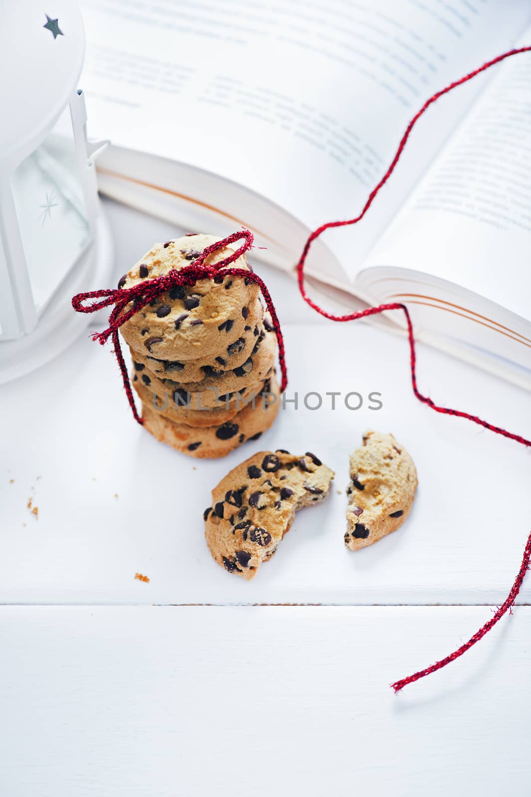American cookies with chocolate next to the book on white table by Michalowski