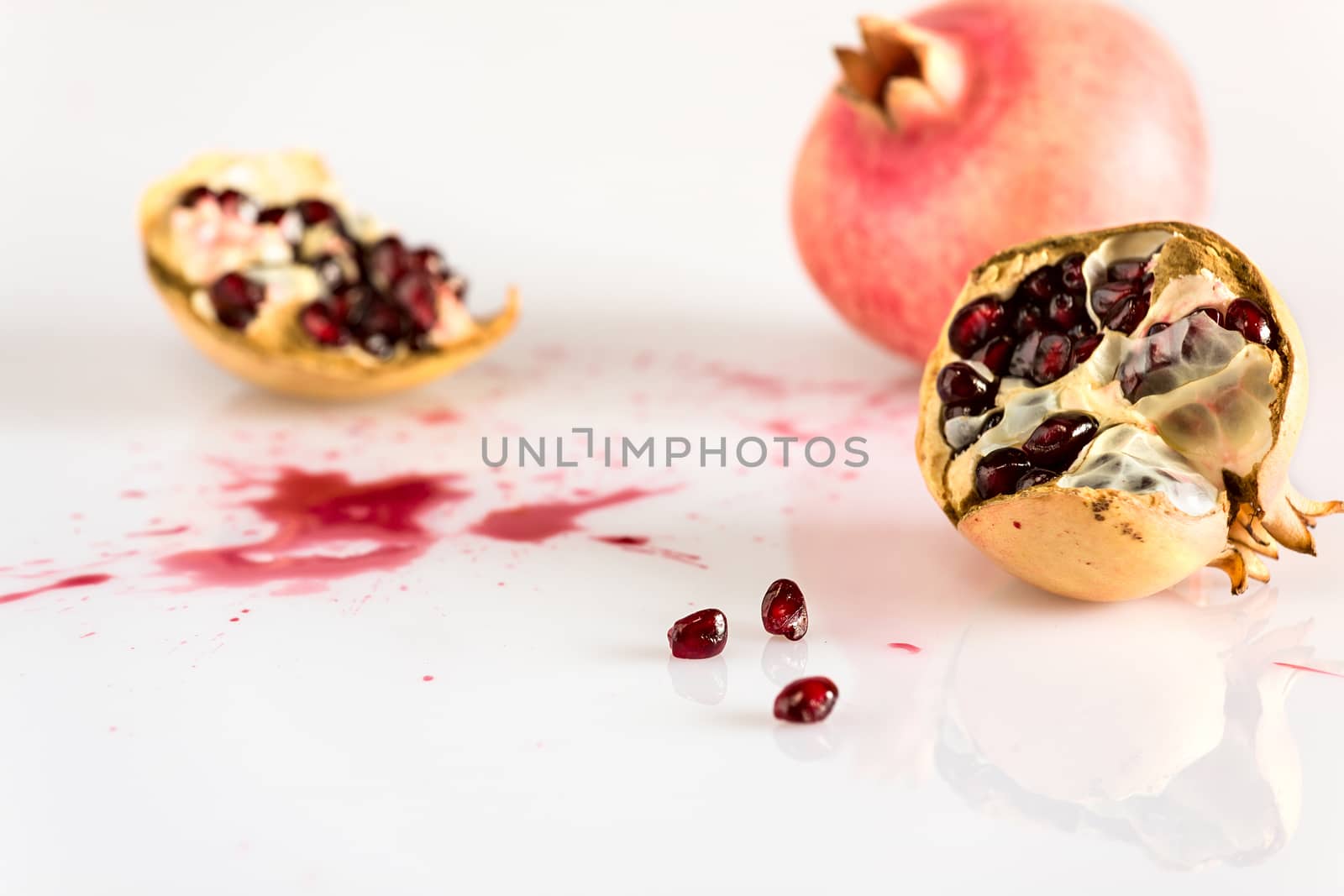 Half pomegranate and juice by LuigiMorbidelli