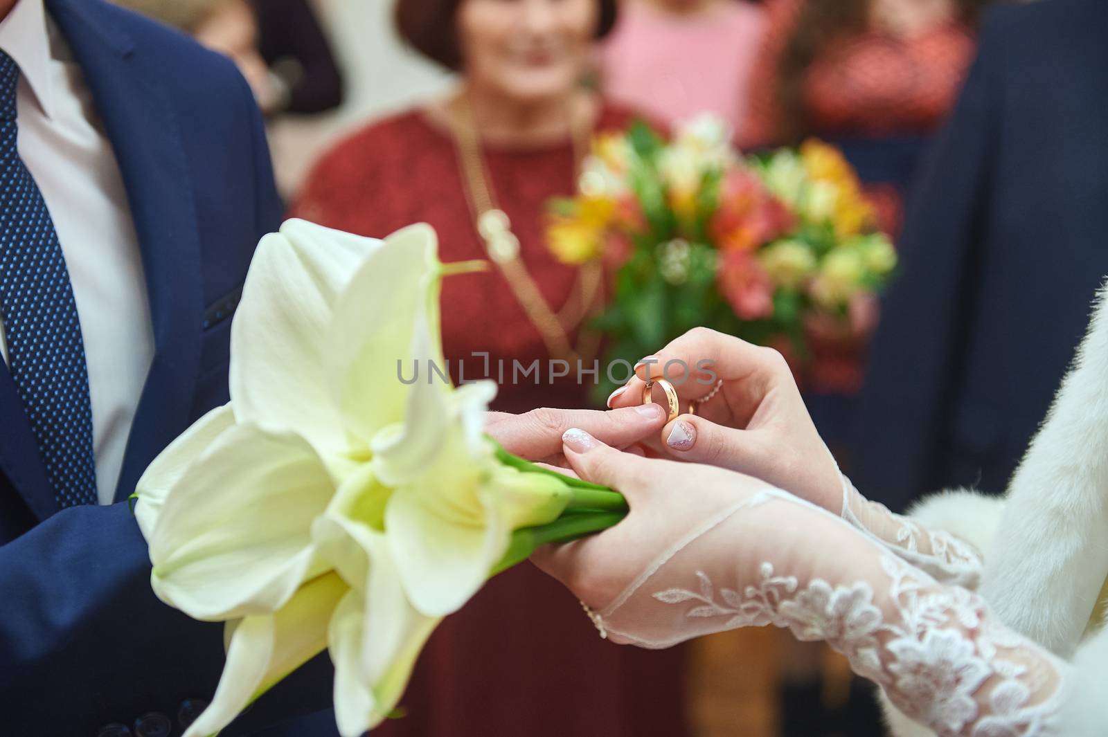 Bride puts ring to groom on wedding ceremony.