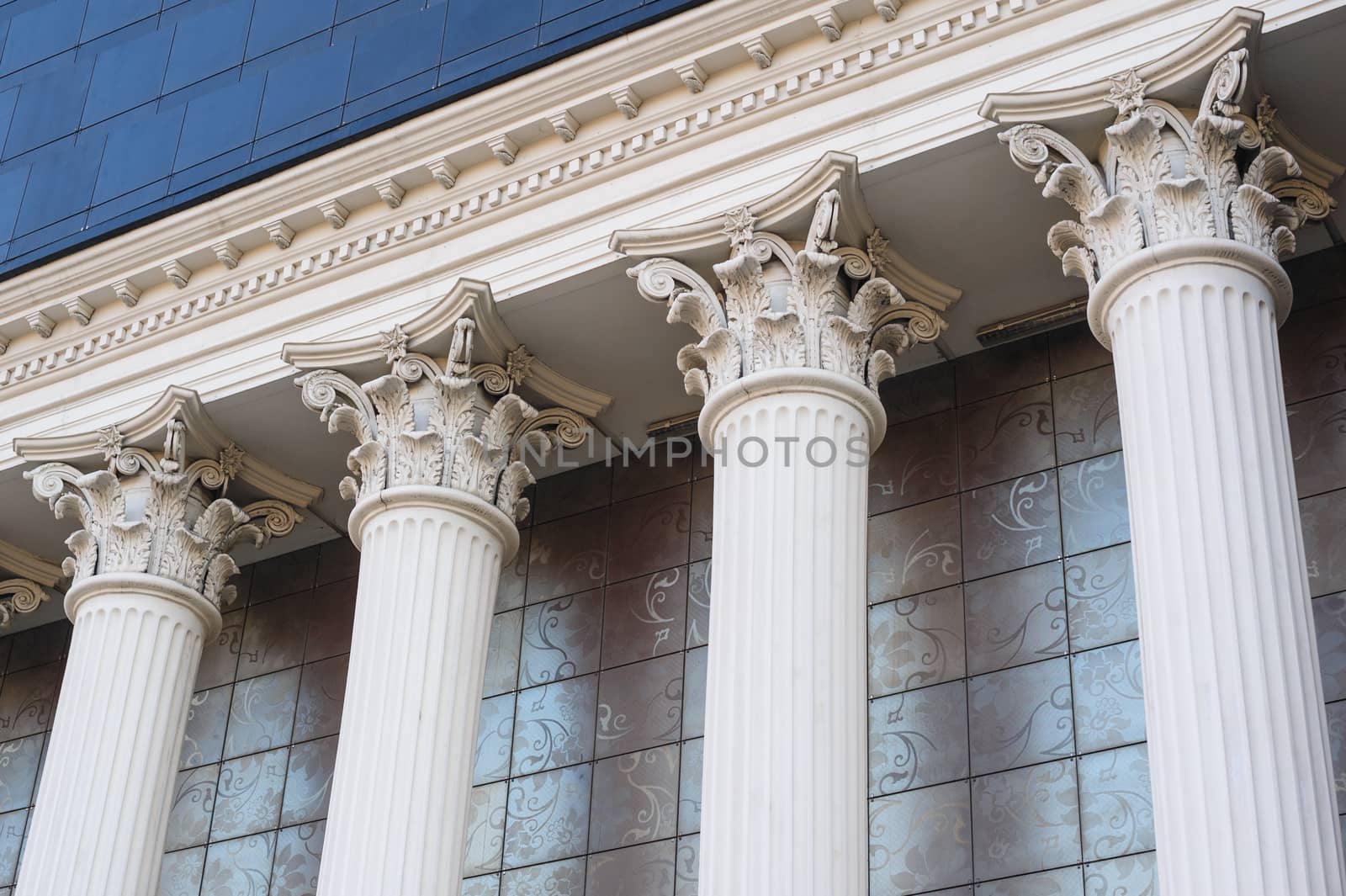 Architectural white Capital columns on the facade of the building.