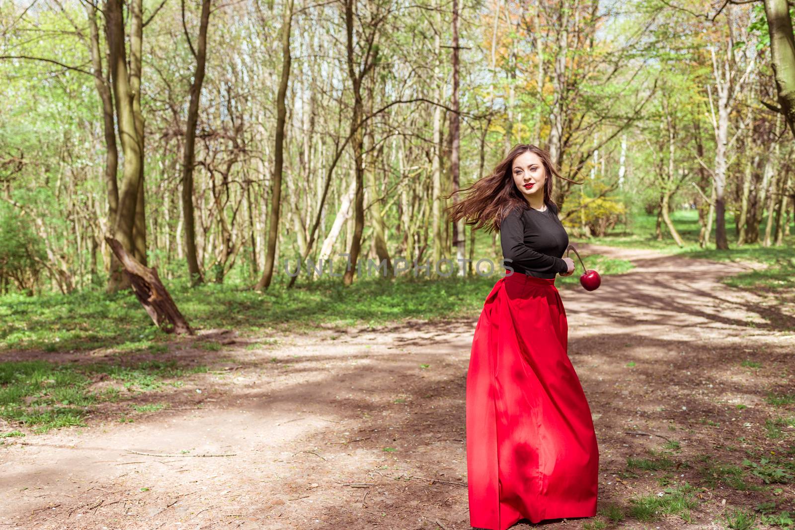 mysterious woman with a sickle in spring forest