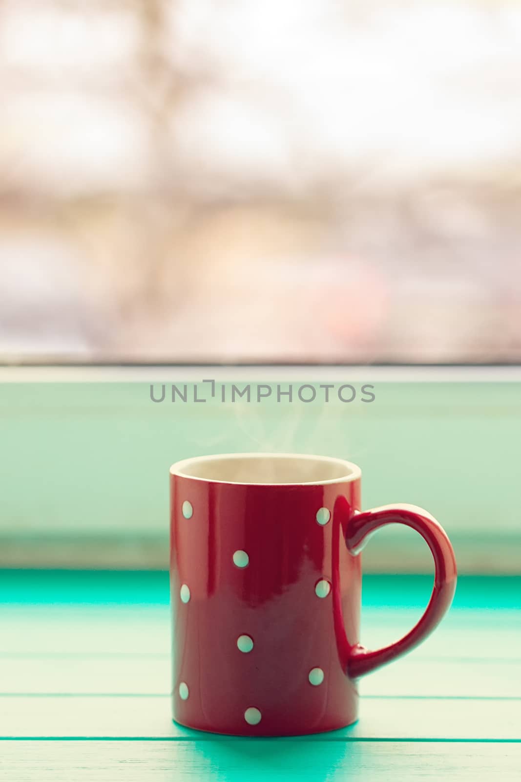 Red cup in white peas on a windowsill