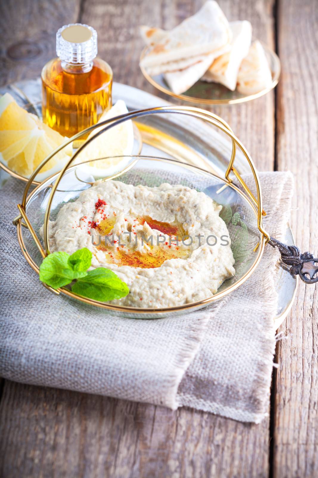 Baba ghanoush, eggplant dip, mediterranean food on a wooden surface