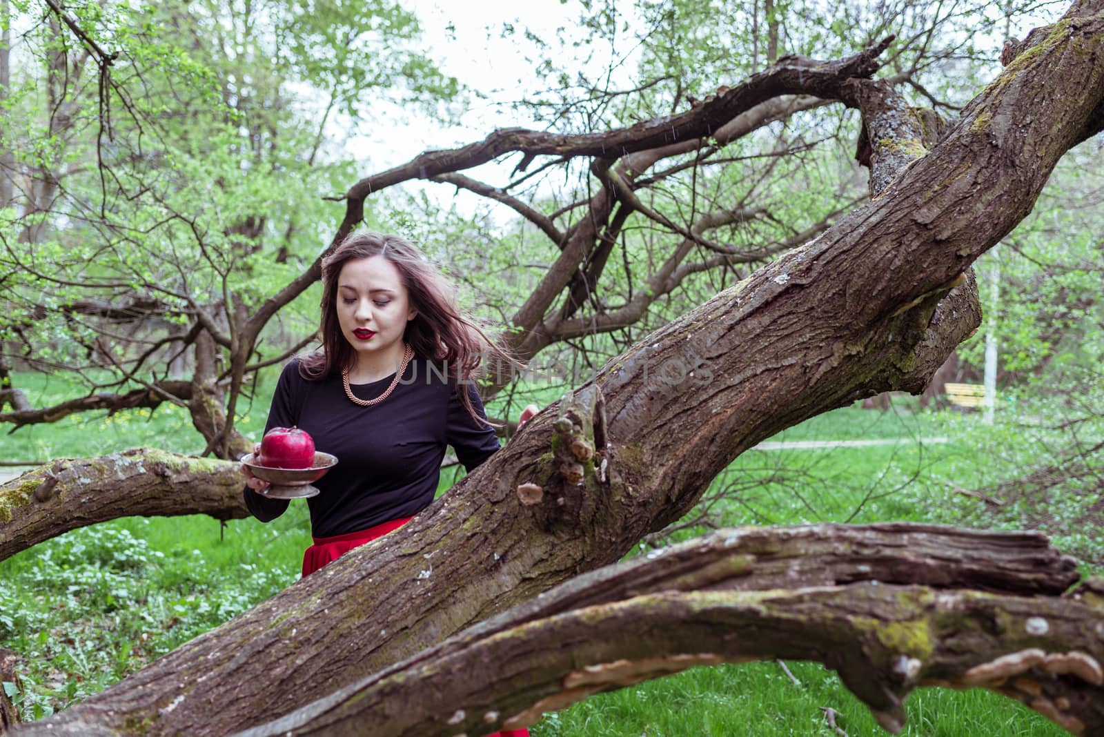 girl standing near a tree trunk by okskukuruza