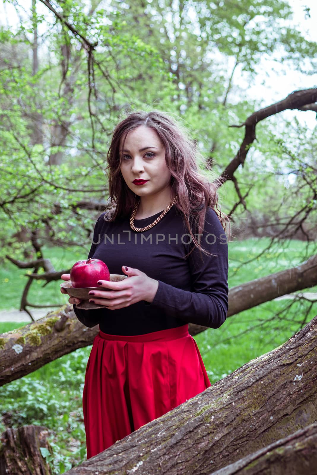 girl standing near a tree trunk by okskukuruza