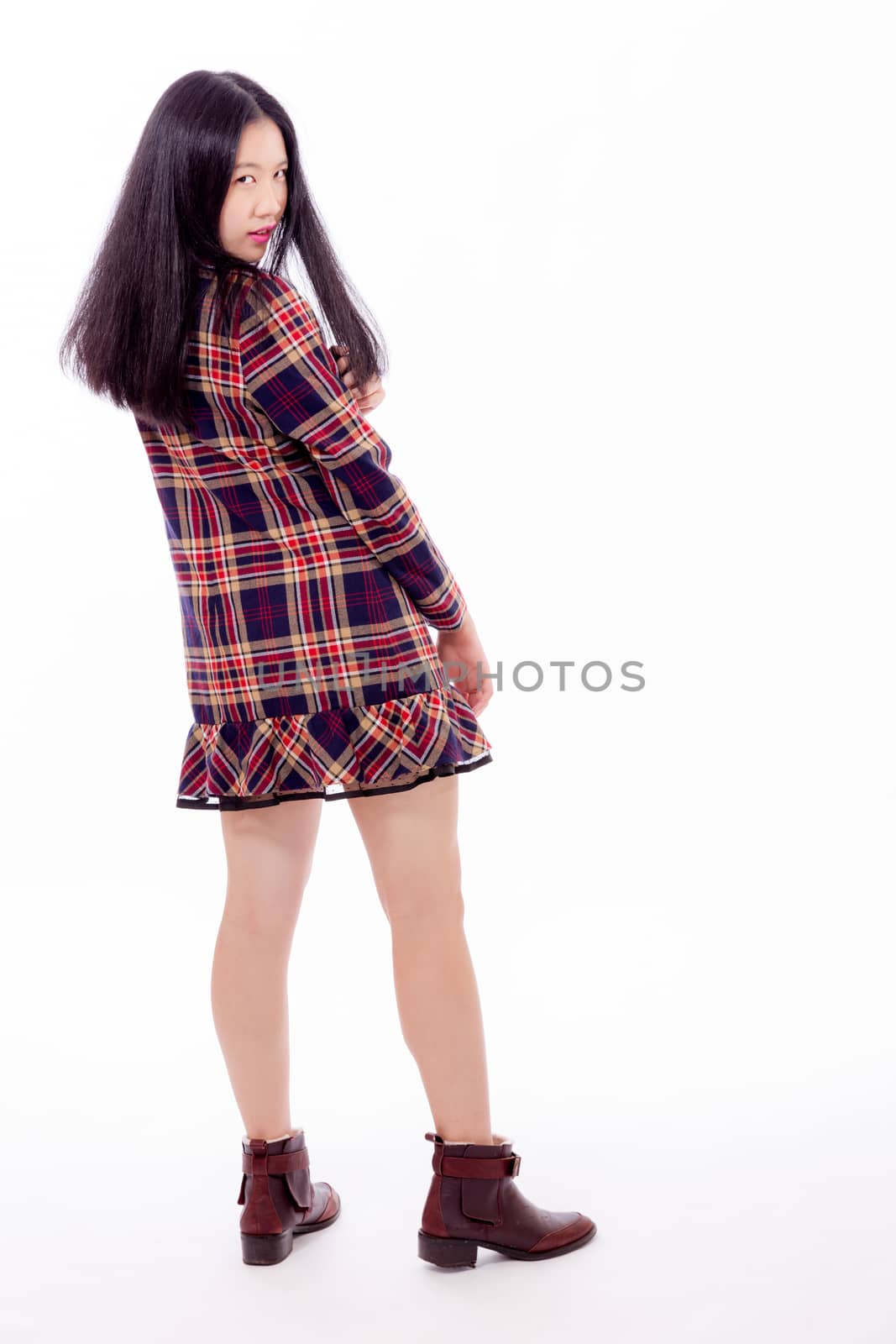Chinese teenager standing, looking over shoulder at camera
