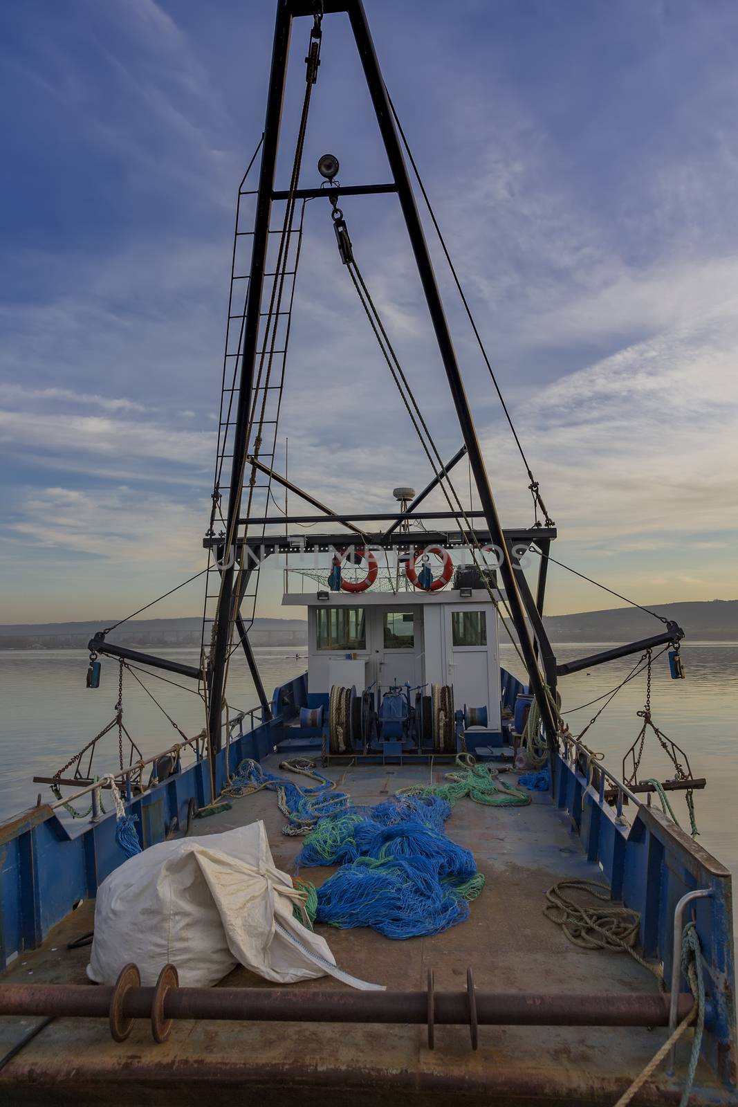 Fishing nets on deck of a fishing boat at pier