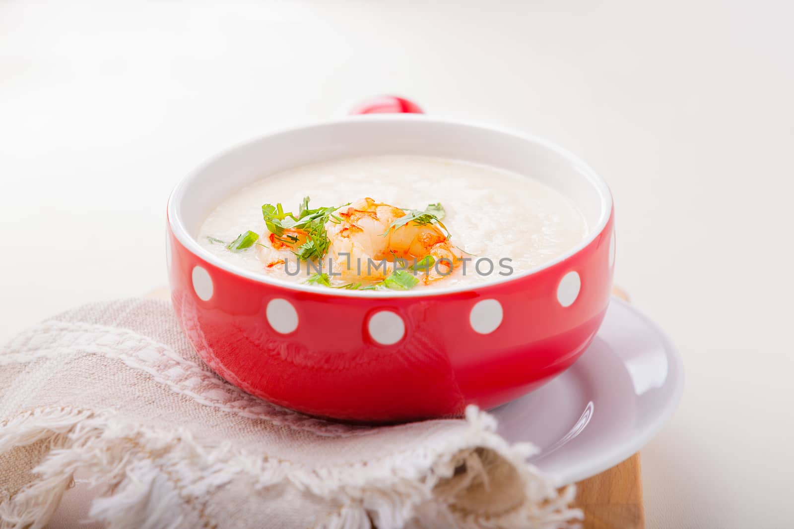 A bowl of creamy cauliflower soup with shrimps. by supercat67