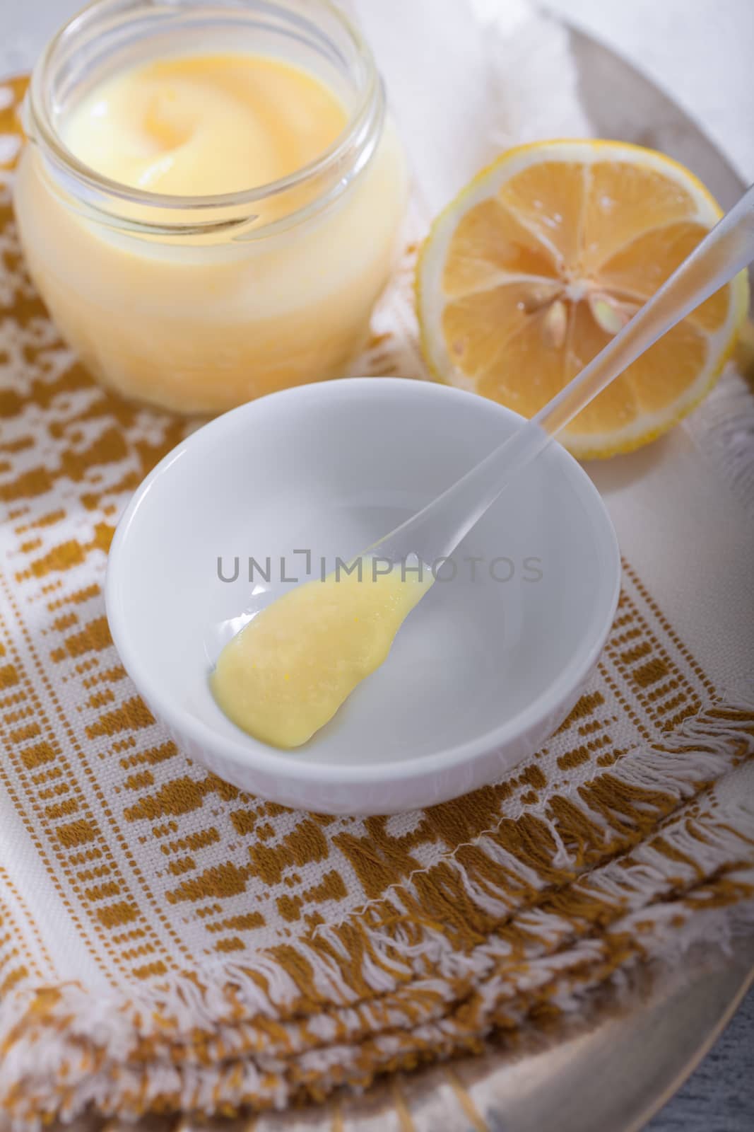 Lemon kurd with a spoon served on a table