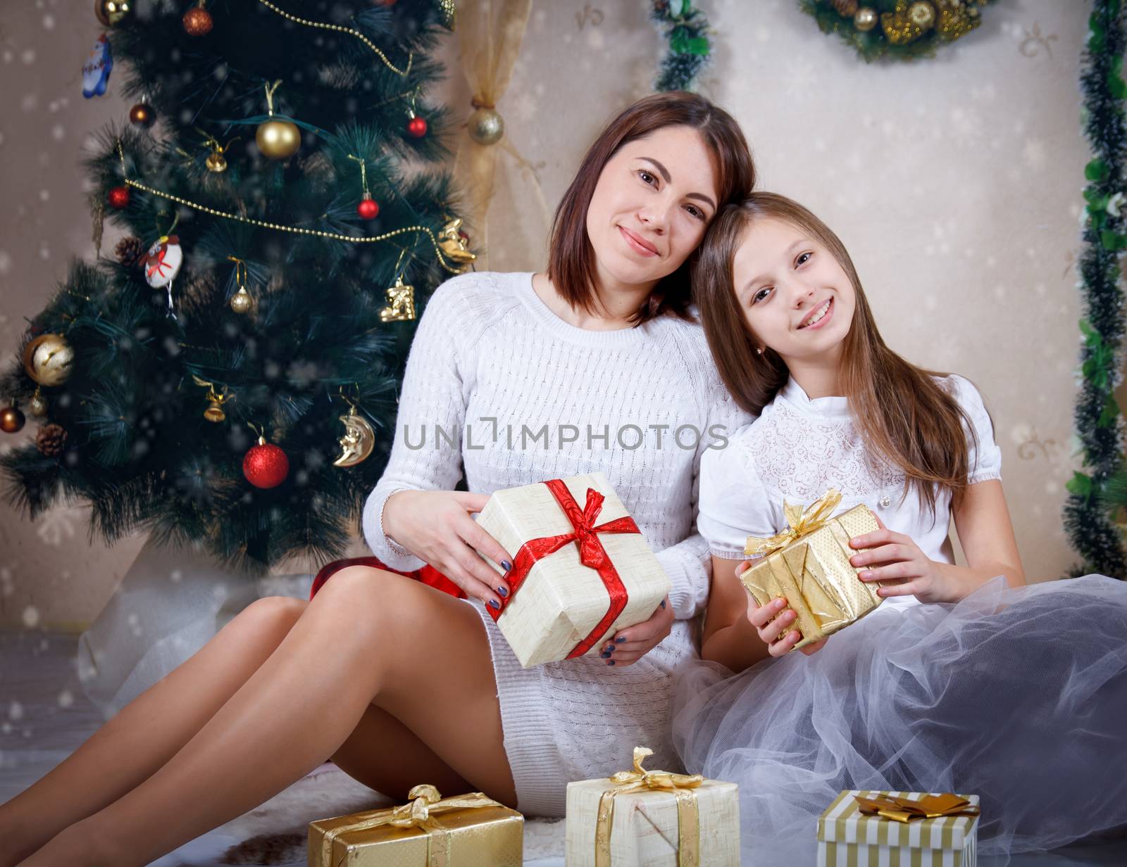 mother and daughter holding Christmas gifts by Angel_a