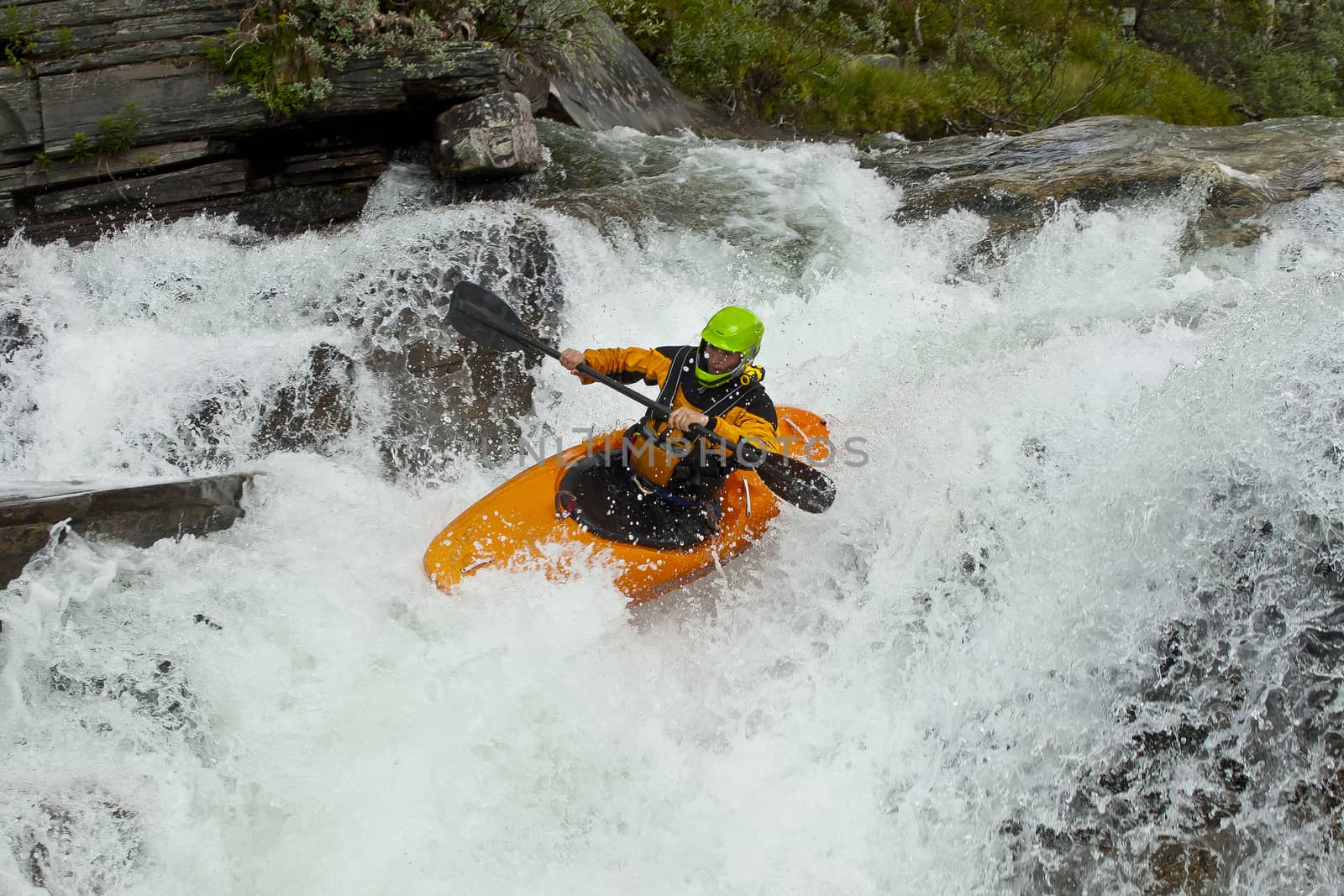 Kayaker in the waterfall by Chudakov