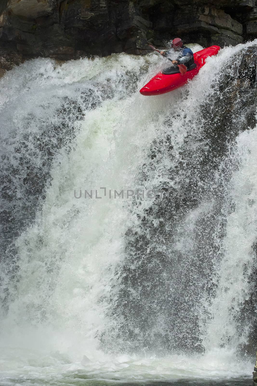 Kayaker in the waterfall by Chudakov