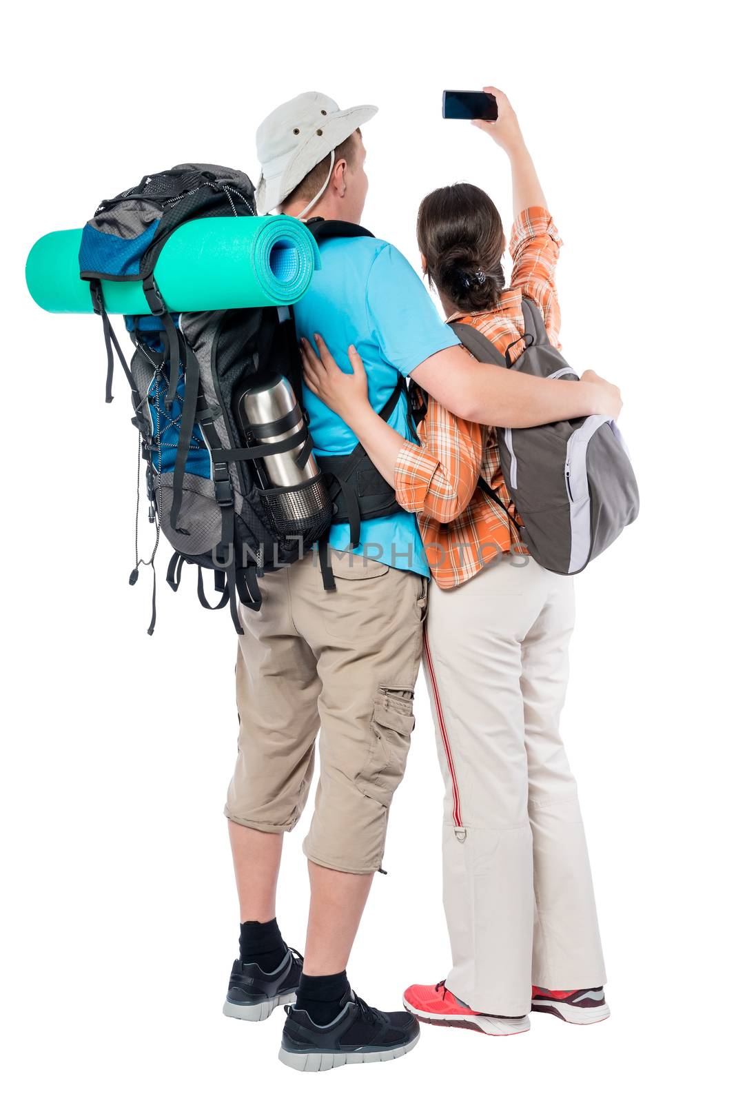 a couple of tourists with backpacks make selfie phone on a white background