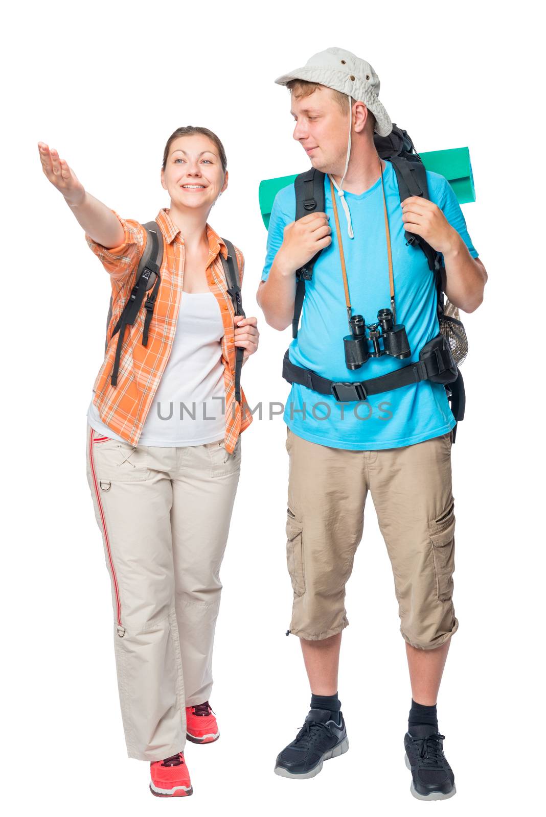 Happy couple of tourists with backpacks on a white background in studio