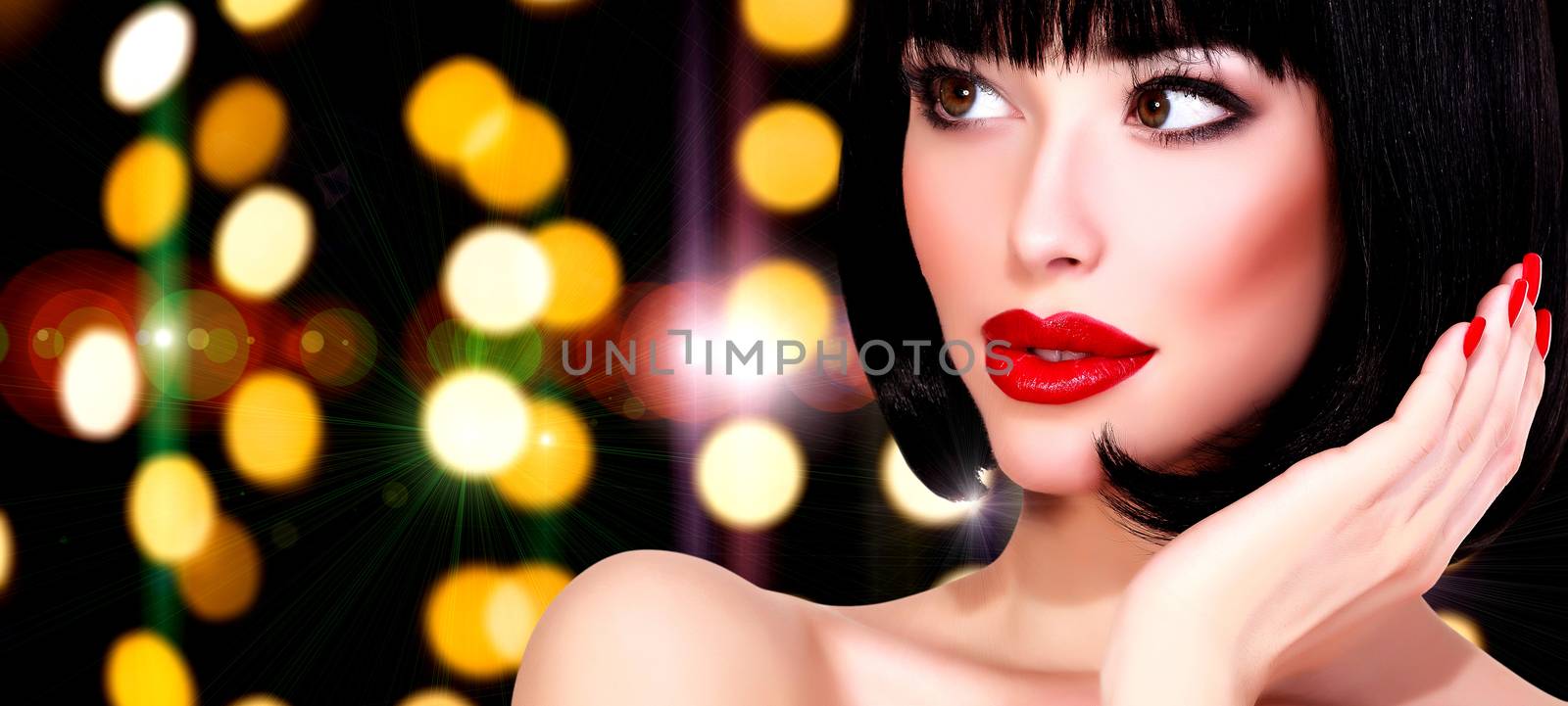 Pretty woman against an abstract background with blurred lights by Nobilior
