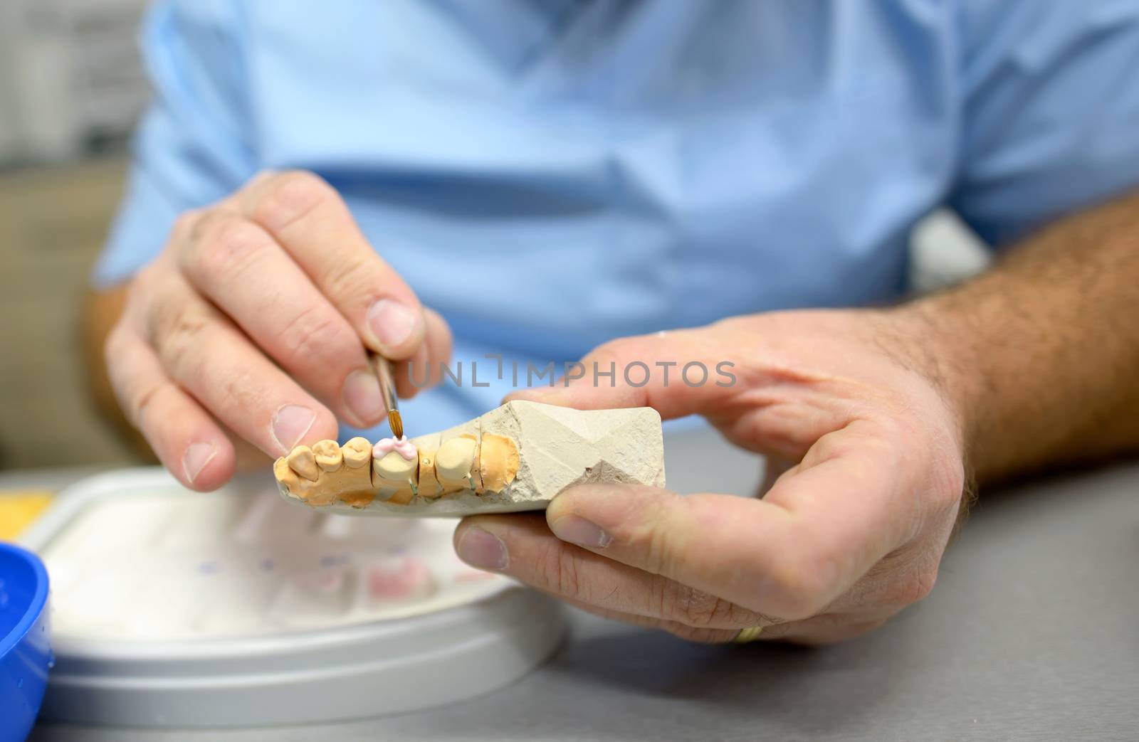 Dental technician in dental laboratory by jordachelr